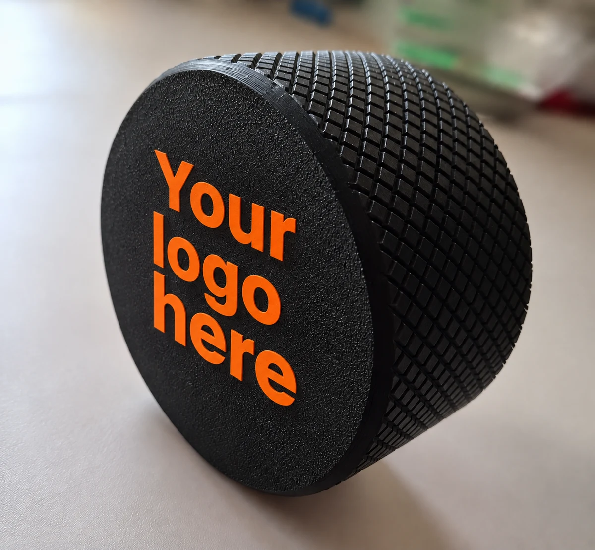 Black knurled jar with an orange YOUR LOGO HERE plaque on the lid
